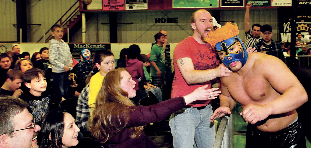 Spectator Mike Jalbert (red shirt), screams at wrestler Todo Loco prior to a match during the Big Time Wrestling event Sunday at Winslow’s Sukee Arena.