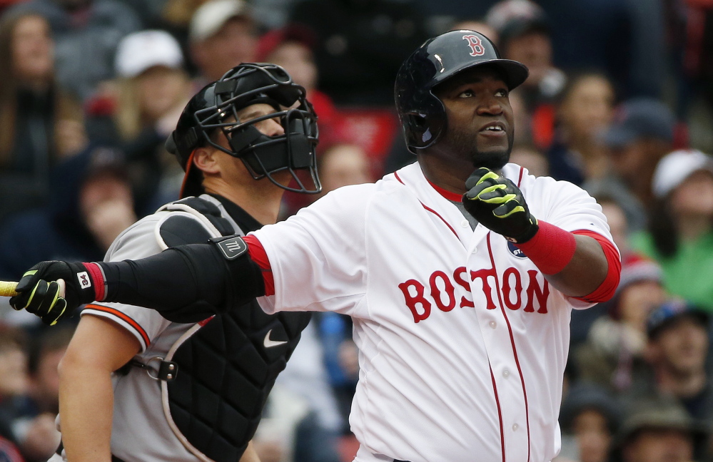 Boston’s David Ortiz watches his sacrifice fly in front of Baltimore Orioles’ catcher Ryan Lavarnway during the first inning in Boston on Monday.