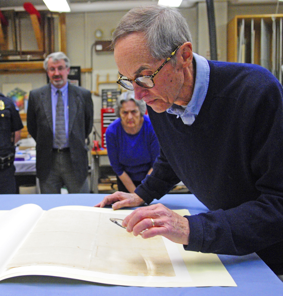 Hallowell City Historian Sam Webber looks at the writing on the back of the city’s 1776 copy of the Declaration of Independence at the Maine State Museum in Augusta.