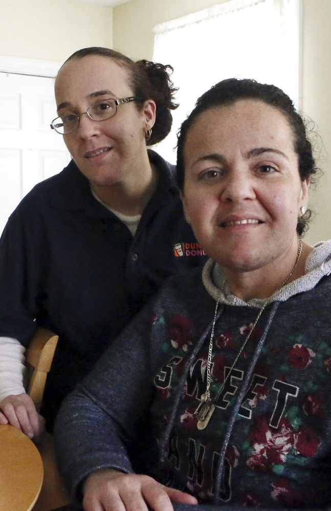 Susane Nunes, left, who is cancer-free, and her sister Dee Noonan, diagnosed with cancer, both chose to undergo surgeries. They share a family history that puts them at high risk for the disease.