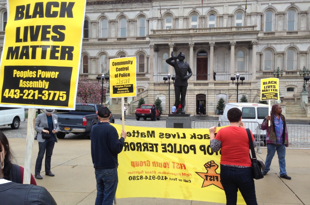 Demonstrators protest the death of Freddie Gray outside Baltimore City Hall on Monday. Gray died Sunday, a week after he was rushed to the hospital with spinal injuries after an encounter with police.
