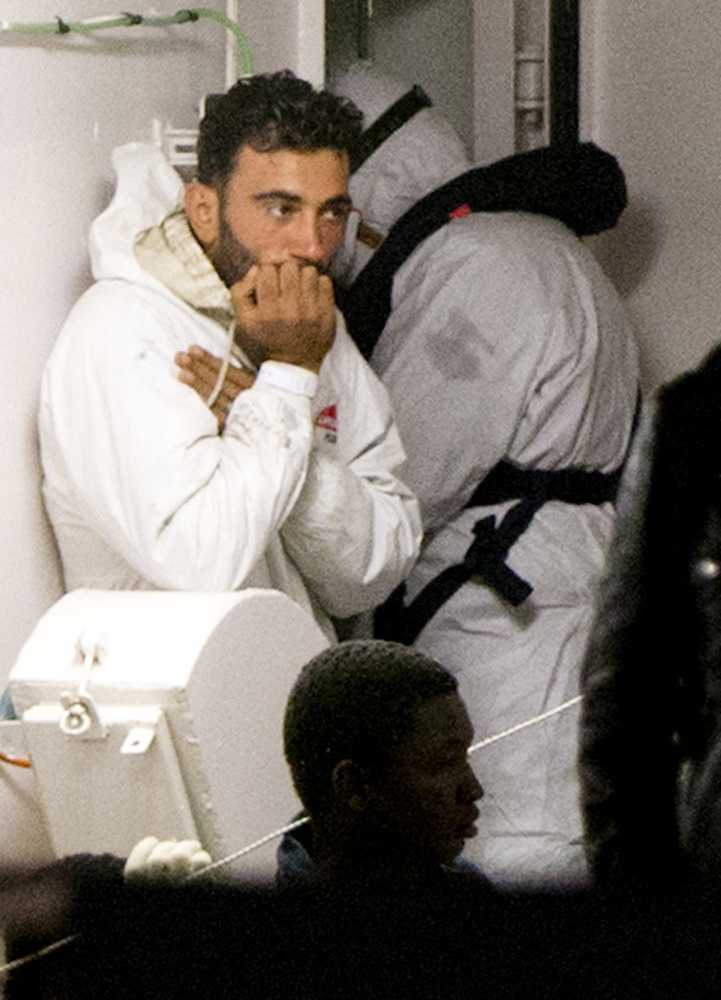 Mohammed Ali Malek, one of the survivors of the boat that overturned off the coast of Libya on Saturday, waits to disembark from Italian Coast Guard ship Bruno Gregoretti, at Catania Harbor, Italy, on Monday. He was among those taken into custody by Italian police on suspicion of being a crew member aboard a smuggler’s boat.