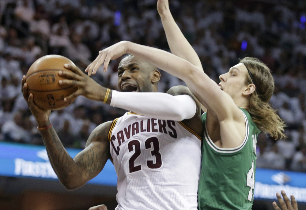 Cleveland Cavaliers' LeBron James, left, drives to the basket against Boston Celtics’ Kelly Olynyk during the fourth quarter of a first-round playoff game Tuesday in Cleveland. 
The Associated Press
