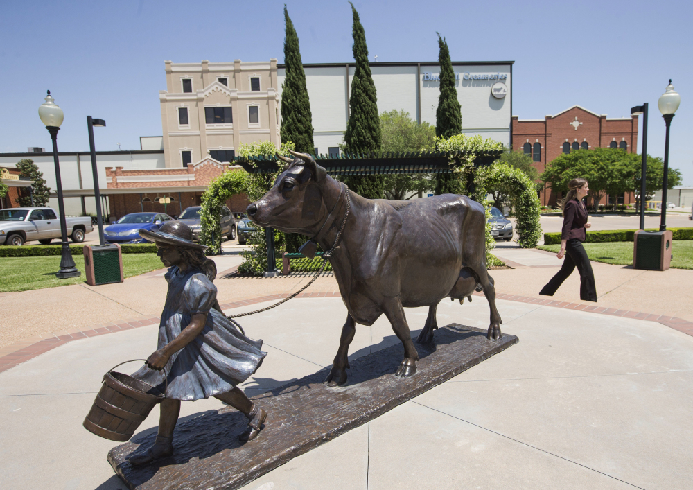 A woman walks by the Blue Bell Creameries on Tuesday, in Brenham, Texas.