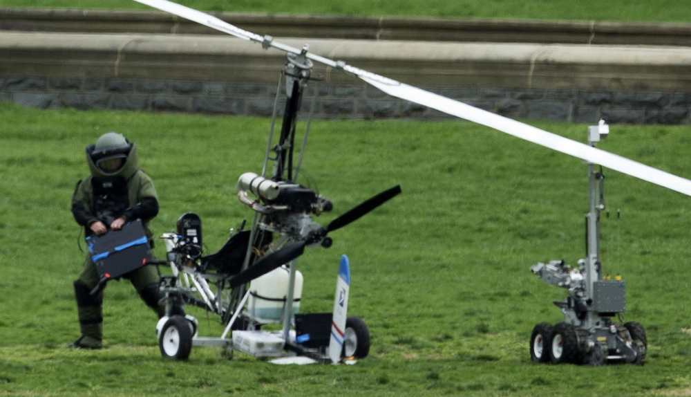 A member of a bomb squad checks the small helicopter that Doug Hughes landed on the U.S. Capitol lawn last week in an apparent effort for campaign finance reform.