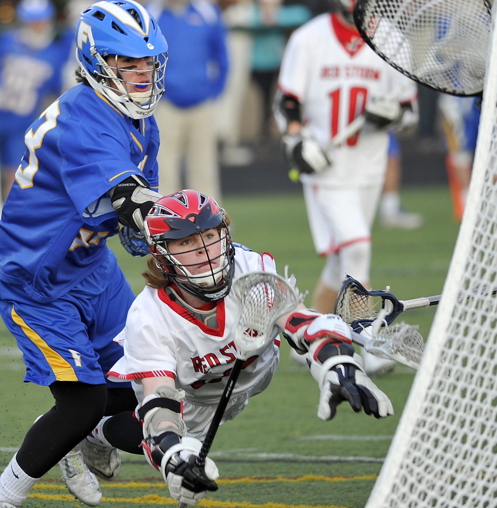Sam Neugebauer dives and puts the ball in the goal, but it did not count because he was in the crease. Neugebauer had three goals and an assist for Scarborough, which lost 11-10 in boys’ lacrosse to Falmouth on Wednesday.