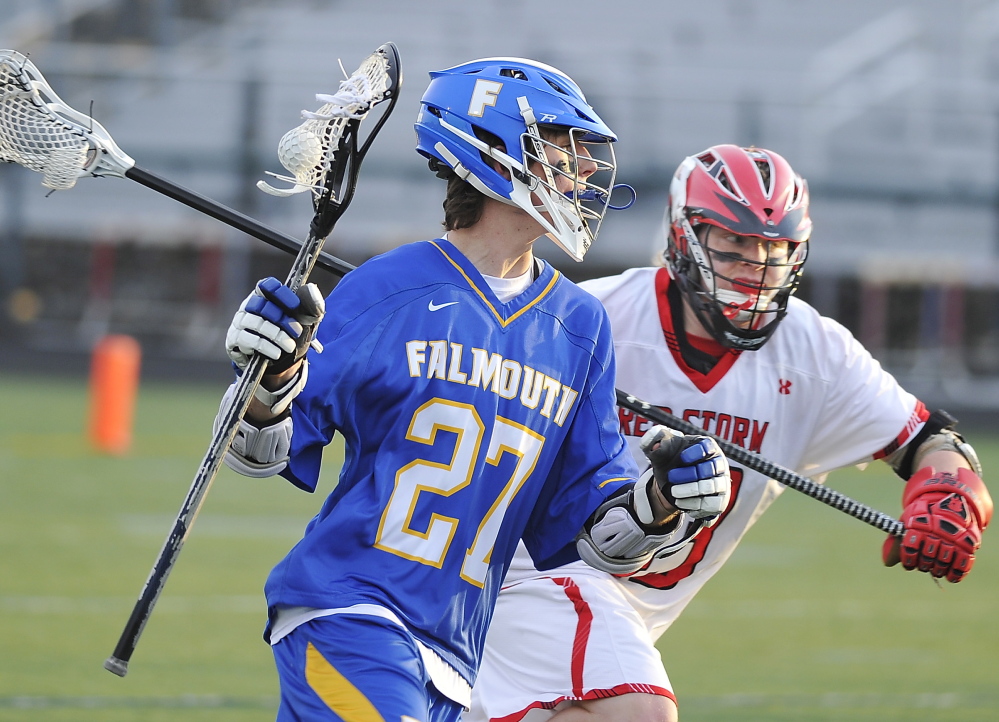 Falmouth’s Bryce Kuhn rushes past Scarborough’s Kevin Caldwell in Wednesday’s game. Kuhn had four goals and an assist as the Yachtsmen improved to 2-0.
