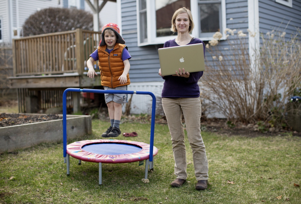 Misty McLaughlin, a nonprofit consultant and user-experience architect, didn’t have to abandon her job when she and her husband moved to Maine from Texas seven years ago; she brought the job with her. Here she is with her 5-year-old son, Iver McLaughlin, in the backyard of their South Portland home.
