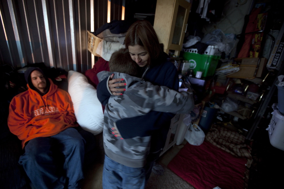 Maria Maior hugs her 12-year-old son inside the storage unit that was their home in 2009 in a Chicago suburb. Homelessness among the nation’s public school students rose 58 percent between the 2007-08 and 2012-13 school years.