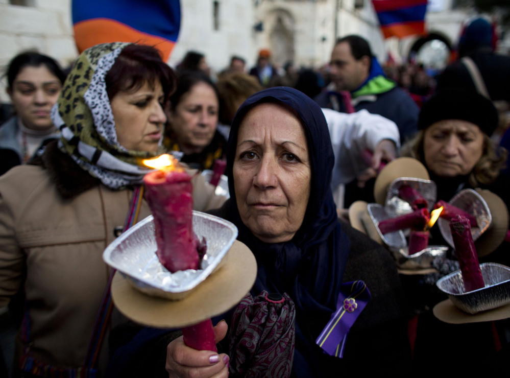 Armenian women in Jerusalem hold torches during a march on Thursday to commemorate the 100th anniversary of what many call the first genocide of the 20th century – in 1915 the Ottoman government began the systematic extermination of its Armenian minority.  The Associated Press
