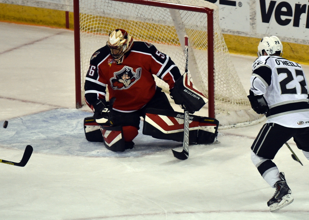 Brian O’Neill of the Manchester Monarchs watches a shot leading to his goal, the fourth of the game against Portland goalie Mike McKenna at the Verizon Wireless Arena in Manchester on Thursday.