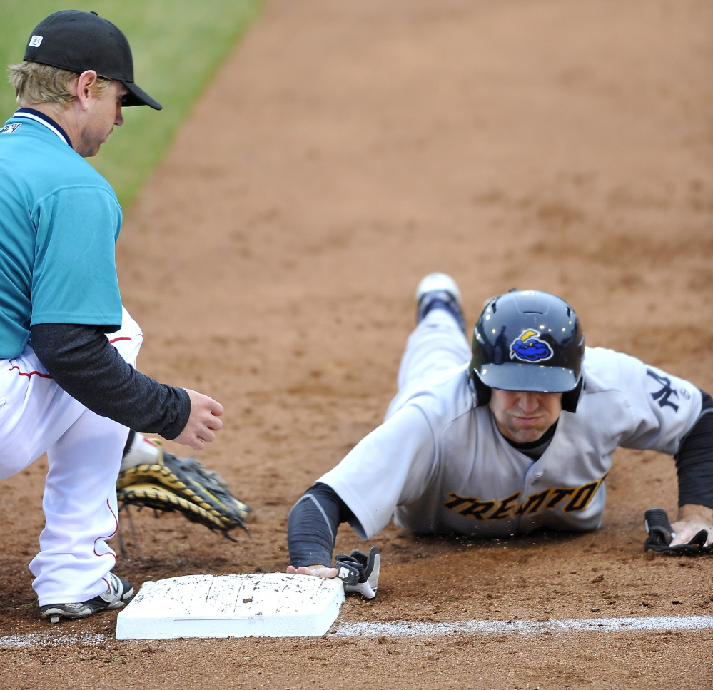 Jake Cave of the Trenton Thunder gets back to first as Michael Brenly of the Portland Sea Dogs reaches to apply a tag during a pickoff attempt Thursday night.