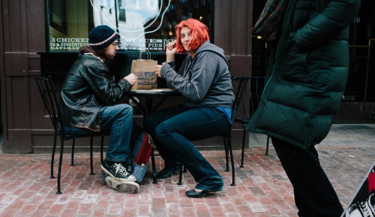 Ben Frost, left, and Channa Schroff eat at Otto Pizza along Congress Street in Portland on Friday. The city revised its guidelines for outdoor dining areas in response to complaints from parents pushing strollers, people in wheelchairs and others.