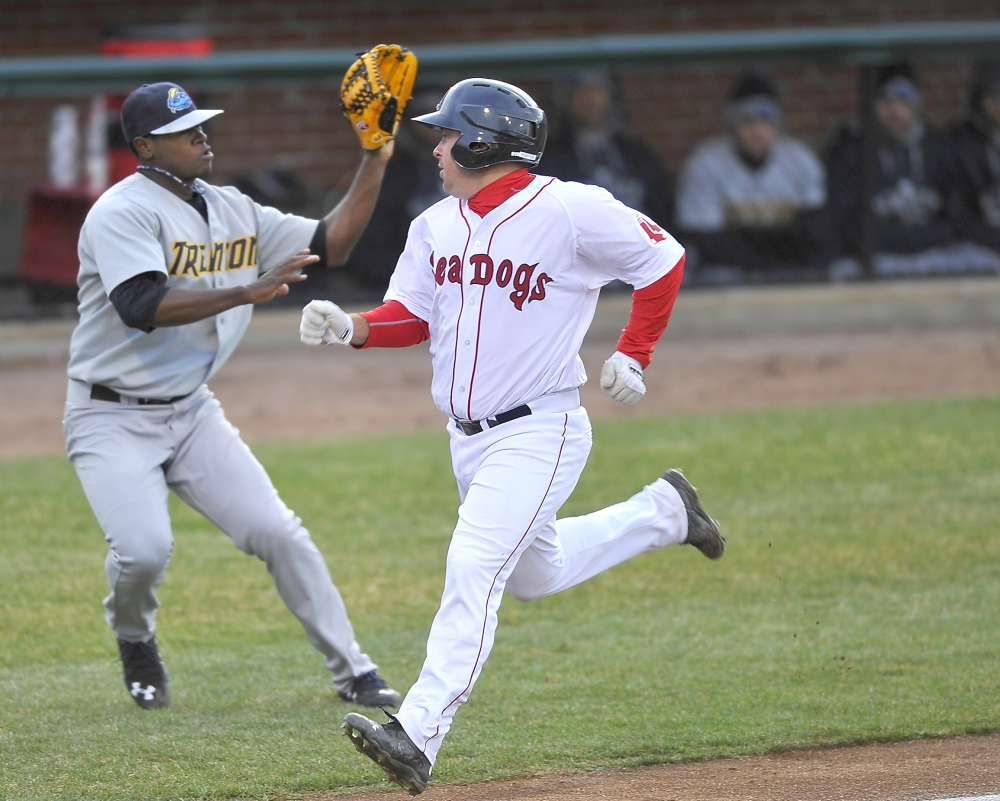 Tim Roberson of the Portland Sea Dogs heads down the line to score as Trenton third baseman Eric Jagielo waits for a throw Friday night.