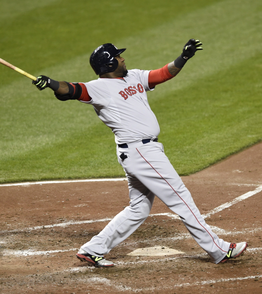 David Ortiz follows through on a three-run homer in the fifth inning Friday against the Baltimore Orioles. Brock Holt also hit a three-run homer, lifting the Red Sox to a 7-5 win.