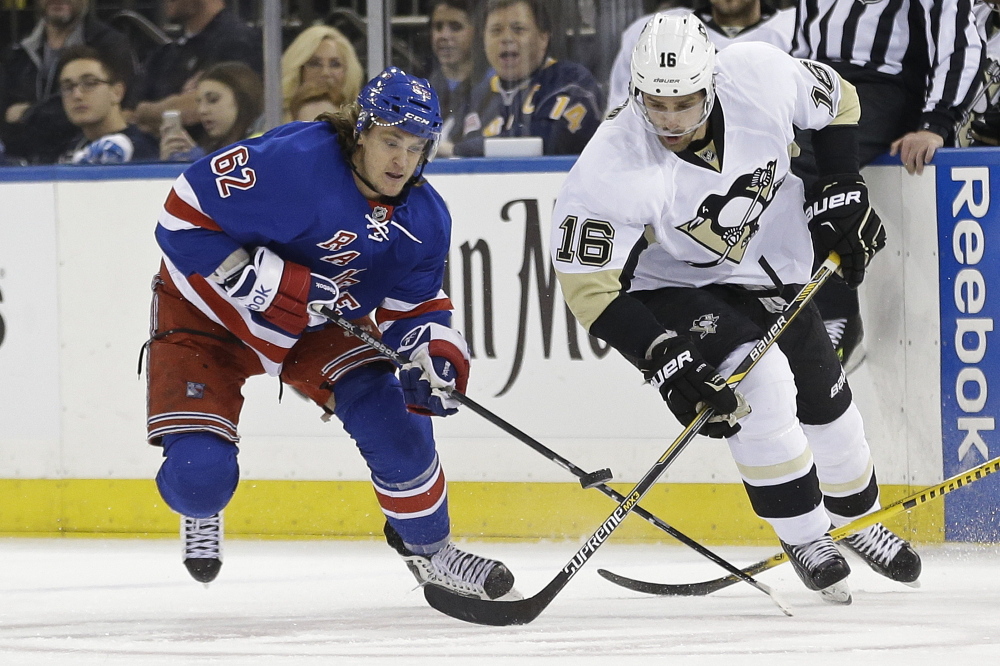 The Rangers’ Carl Hagelin and the Penguins’ Brandon Sutter fight for control of the puck during the Rangers’ 2-1 overtime win in Game 5 at Madison Square Garden.