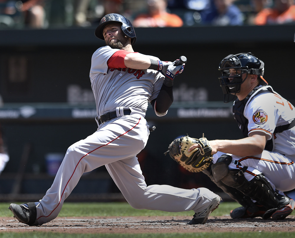 Red Sox second baseman Dustin Pedroia follows through on a double against the Baltimore Orioles in the second inning Sunday in Baltimore.