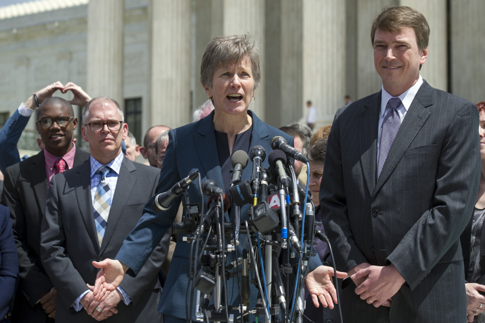 Attorney Mary Bonauto of Portland, center, speaks outside the Supreme Court on Tuesday as plaintiff James Obergefell of Ohio, left, and Washington attorney Douglas Hallward-Driemeier, right, listen. She argued in court that rights are being compromised.