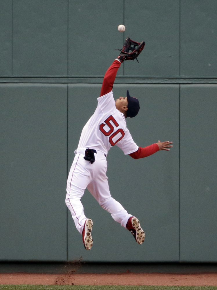 Red Sox center fielder Mookie Betts makes a tumbling catch on a deep fly ball by the Toronto Blue Jays’ Devon Travis in the third inning Wednesday night at Fenway Park.