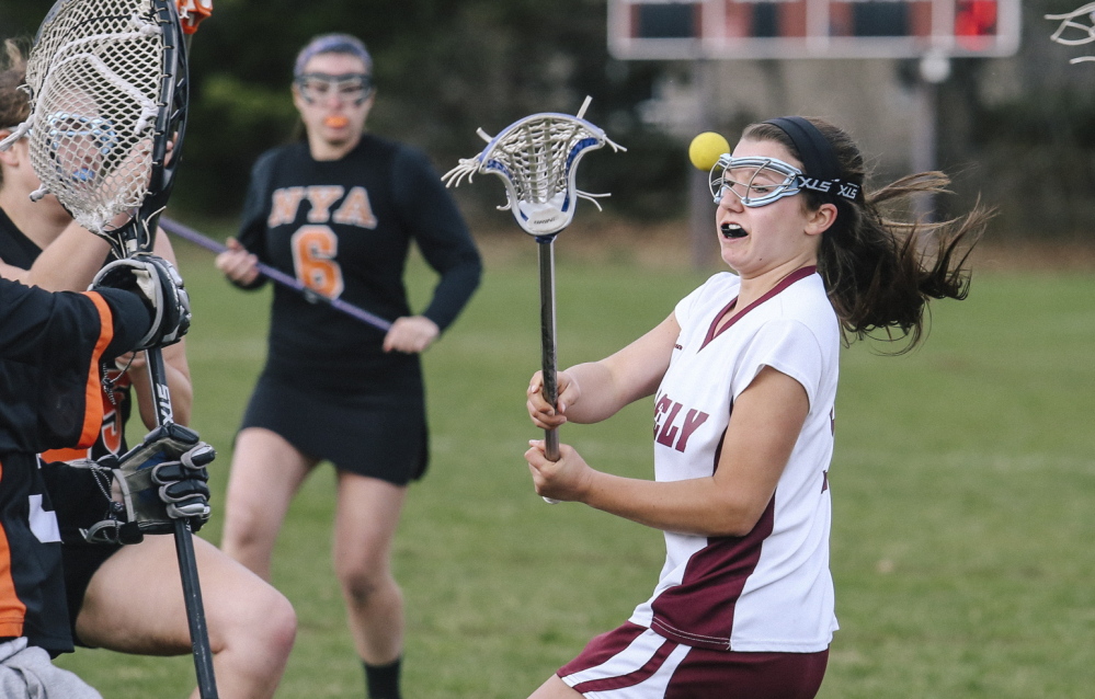 Ellie Schad, who scored two goals Wednesday for Greely, takes on the North Yarmouth Academy defense during their girls’ lacrosse game. Greely came away with a 12-7 victory at Cumberland.