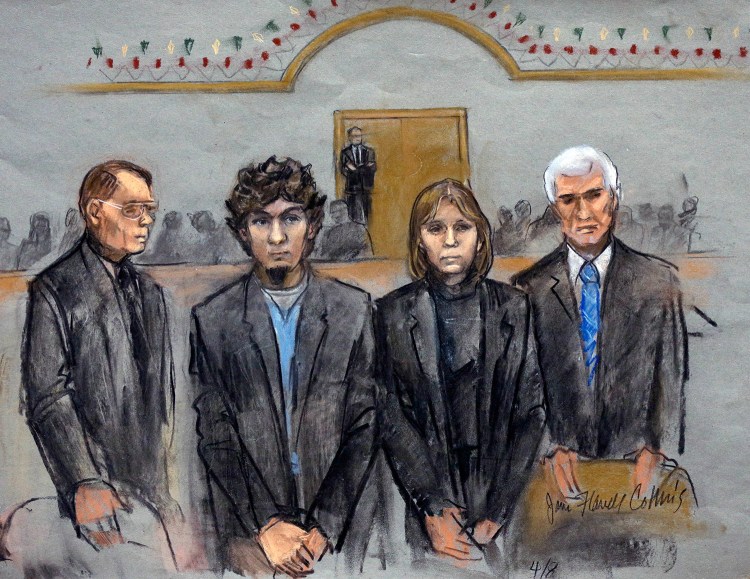  In this courtroom sketch, Dzhokhar Tsarnaev, second from left, is depicted standing with his defense attorneys William Fick, left, Judy Clarke, second from right, and David Bruck as the jury presents its verdict in his federal death penalty trial Wednesday in Boston.