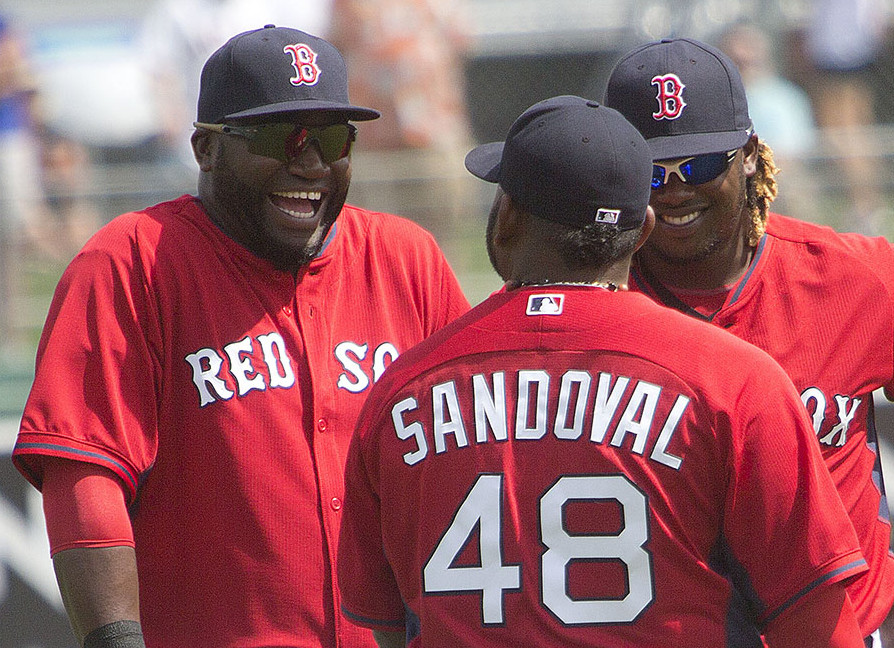 David Ortiz, left, Pablo Sandoval and Hanley Ramirez chat during a spring training game  in Fort Myers, Fla., In this March 3, 2015, photo. The Associated Press
