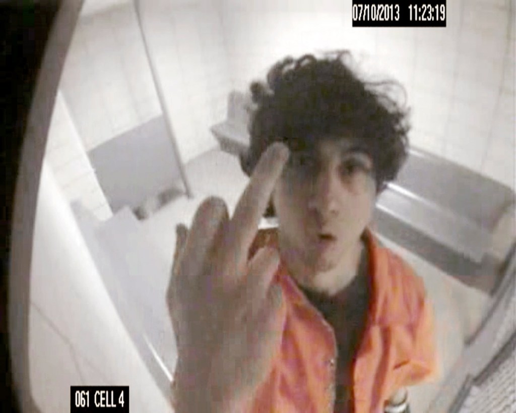 In this July 10, 2013, surveillance photo released by the U.S. Attorney's office, Dzhokhar Tsarnaev extends his middle finger in an obscene gesture to a security camera in his jail cell in Devens, Mass. The photo was presented during the penalty phase of Tsarnaev's trial on Tuesday as a federal prosecutor laid out the government's case for executing him.
