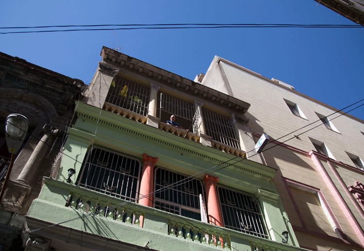 Homeowner Israel Ribero looks from his home with rooms for rent in Havana, Cuba Wednesday. The wildly popular online home-sharing service Airbnb will allow American travelers to book lodging in Cuba starting Thursday in the most significant U.S. business expansion on the island since the declaration of detente between the two countries late last year. The Associated Press