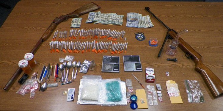 Among the items seized at a Dedham house Tuesday were bath salts with a street value of about $68,000, more than 70 needles and two rifles.