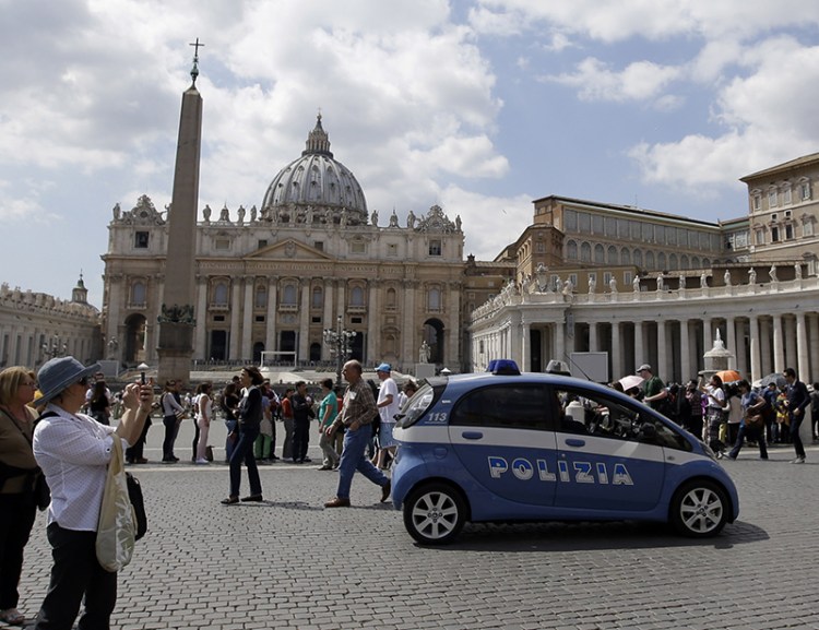 A police car patrols in St. Peter's Square at the Vatican Friday. Islamic extremists suspected in a bomb attack in a Pakistani market that killed more than 100 people had also planned an attack against the Vatican in 2010 that was never carried out, an Italian prosecutor says. The Associated Press