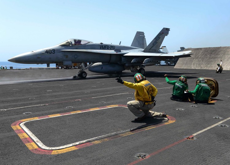 An F/A-18C Hornet launches from the flight deck of the aircraft carrier USS Theodore Roosevelt during operations in the Arabian Sea.