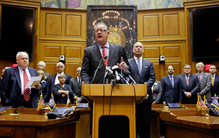 Indiana Senate President Pro Tem David Long, left, R-Fort Wayne, and House Speaker Brian C. Bosma, R-Indianapolis, are joined by business leaders as they announce proposed changes to the state's new "religious objections" law at the Statehouse in Indianapolis Thursday. The Associated Press