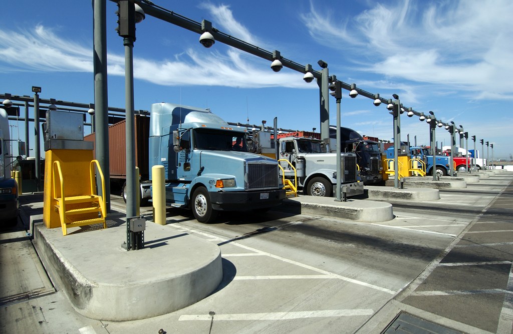 Tractor-trailers pass through a checkpoint at the Port of Los Angeles in this courtesy photo. The Teamsters say drivers have been victims of "persistent wage theft" from employers because they are treated as independent contractors instead of employees.