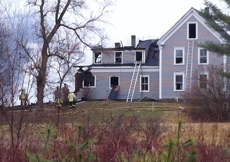 Crews at the scene of a house and barn fire at 91 Union Falls Road in Dayton. Photo courtesy WCSH-TV