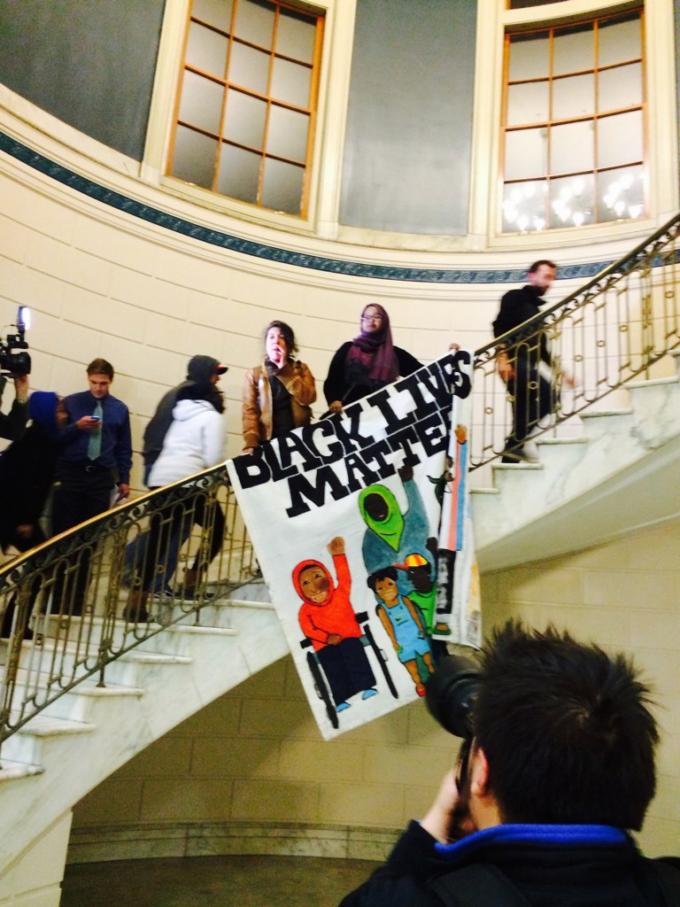 Protesters decrying racism move upstairs at Portland City Hall to address Mayor Michael Brennan on Thursday night in the City Council chambers.