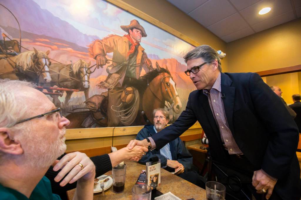Former Texas Gov. Rick Perry greets voters during a meet and greet event at Pizza Ranch in Sioux Center, Iowa. Perry is making a hands-on pitch in Iowa after mostly avoiding retail politics there in the 2012 primary.
