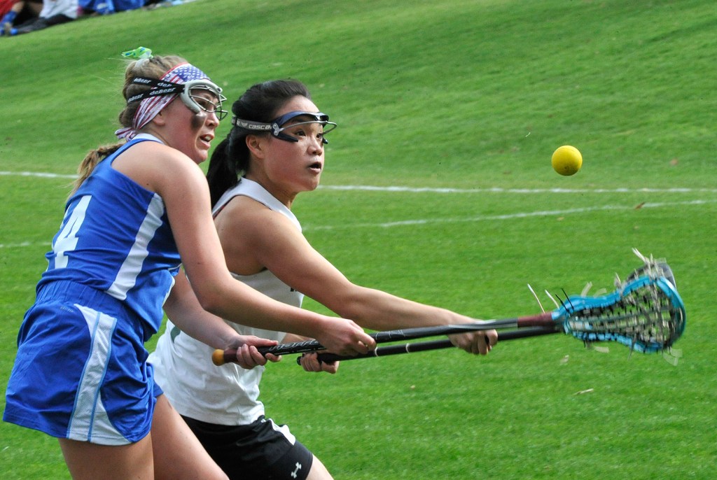 Kennebunk's Carly Sandler and Waynflete's Helen Gray-Bauer chase the ball during Kennebunk's high school girls' lacrosse victory May 4.
