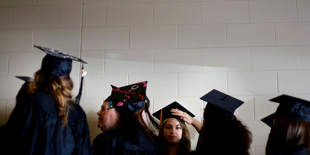 Graduates do some last minute fixing of caps as they line up to enter Cross Insurance Center for the Southern Maine Community College graduation. Derek Davis/Staff Photographer