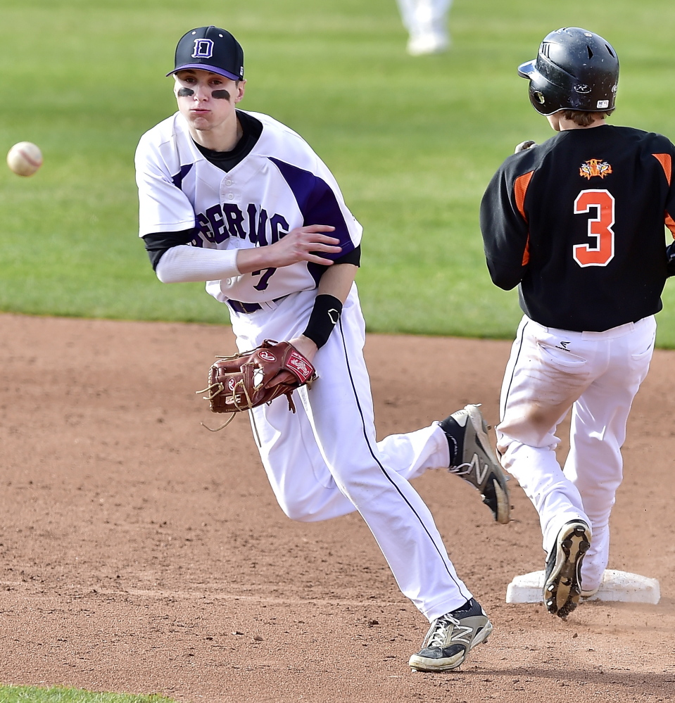 Deering shortstop Nick Bevilacqua fires to first base in an attempt to complete a double play after forcing Sam Collins of Biddeford at second base. Deering scored three runs in the seventh inning to pull out the victory.