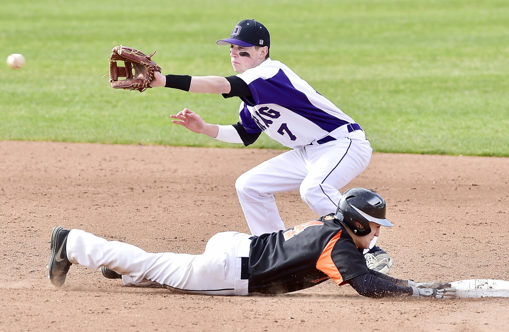 Deering shortstop Nick Bevilacqua waits for a late pickoff throw Thursday as Joe Curit of Biddeford slides safely back to second base during Deering’s 6-5 victory at Hadlock Field.