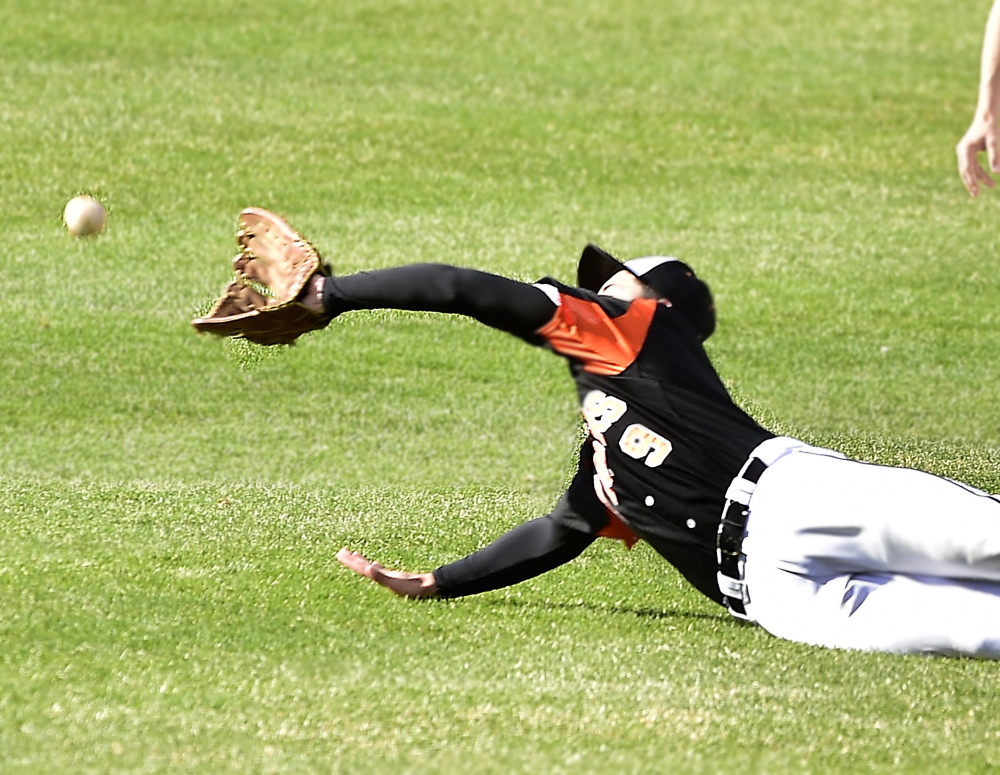 Nick Conley of Biddeford dives in a vain attempt to catch a fly ball hit to center field Thursday during the SMAA game against Deering at Hadlock Field. Deering emerged with a 6-5 victory.