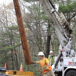 Workers from FairPoint Communications replace a utility pole in Westbrook. The company has filed a bill that would roll back the requirement that the telecommunications firm and others have to provide basic phone service to the remotest parts of the state, no matter the cost to the company. Opponents of the bill say eliminating the mandate would imperil rural elderly and others who need reliable phone service for emergency calls and other uses. 2012 Maine Sunday Telegram File Photo/John Patriquin