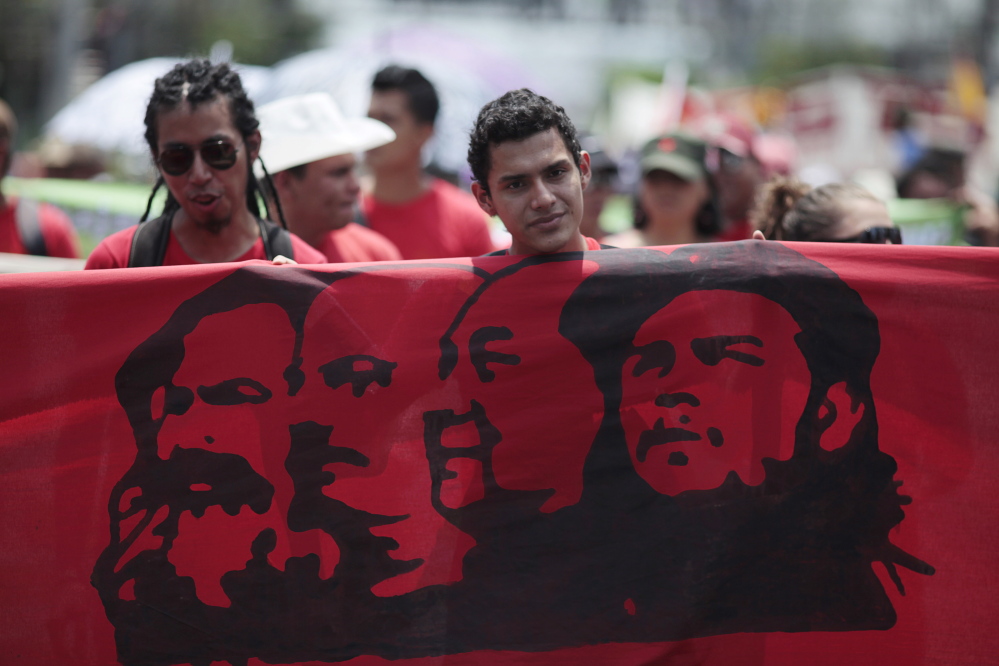 Workers march during the May Day celebration in San Salvador May 1, 2015. International Worker's Day, also known as Labour Day or May Day, commemorates the struggle of workers in industrialised countries in the 19th century for better working conditions. REUTERS/Jose Cabezas  - RTX1B5N8