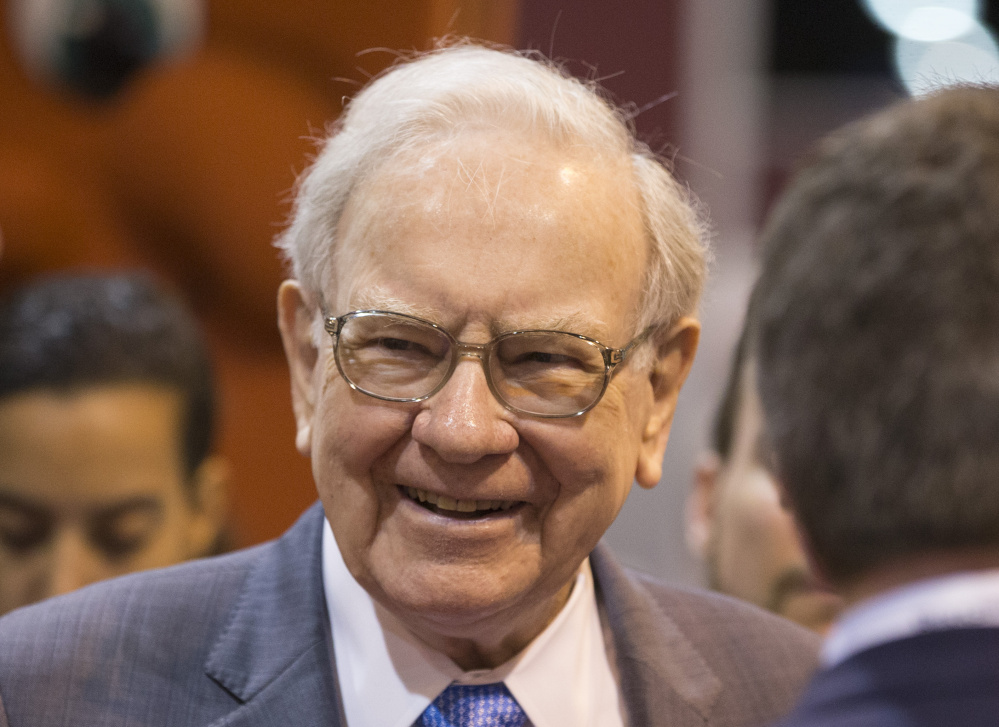 Berkshire Hathaway Chairman and CEO Warren Buffett smiles while touring the exhibit floor before presiding over the annual shareholders meeting in Omaha, Neb., on Saturday.