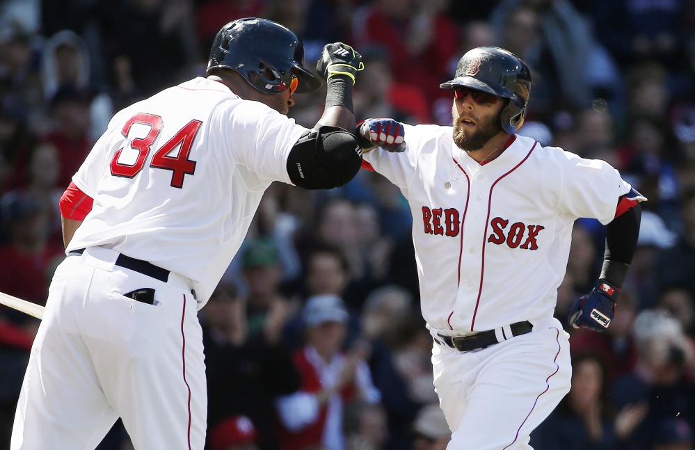 Dustin Pedroia, right, celebrates his solo home run with David Ortiz in the fourth inning against the New York Yankees in Boston on Saturday. The Associated Press 