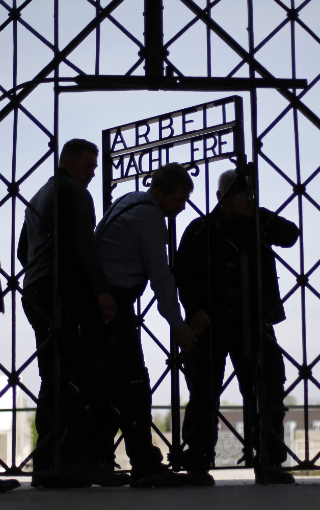 Blacksmiths prepare a replica of the Dachau concentration camp gate, with the slogan “Arbeit macht frei” (“Work sets you free”) at the main entrance to the memorial in Dachau, Germany, on Wednesday. The gate was stolen in November.