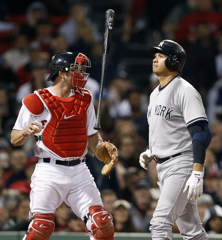 Alex Rodriguez flips his bat in front of Red Sox catcher Blake Swihart after striking out in the eighth inning. Boston fell below .500 for the first time this year after its 8-5 loss.