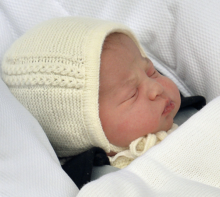 The newborn baby princess, born to parents Kate Duchess of Cambridge and Prince William, is carried in a car seat by her father from The Lindo Wing of St. Mary’s Hospital, in London, Saturday.