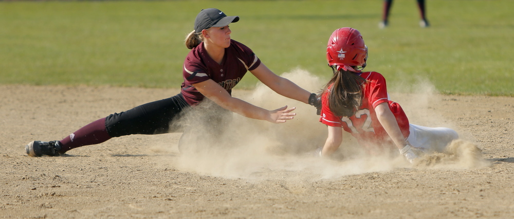 Thornton Academy’s Brooke Cross applies a late tag as Scarborough’s Hannah Ricker steals second base. Ricker scored the winning run in the sixth inning.