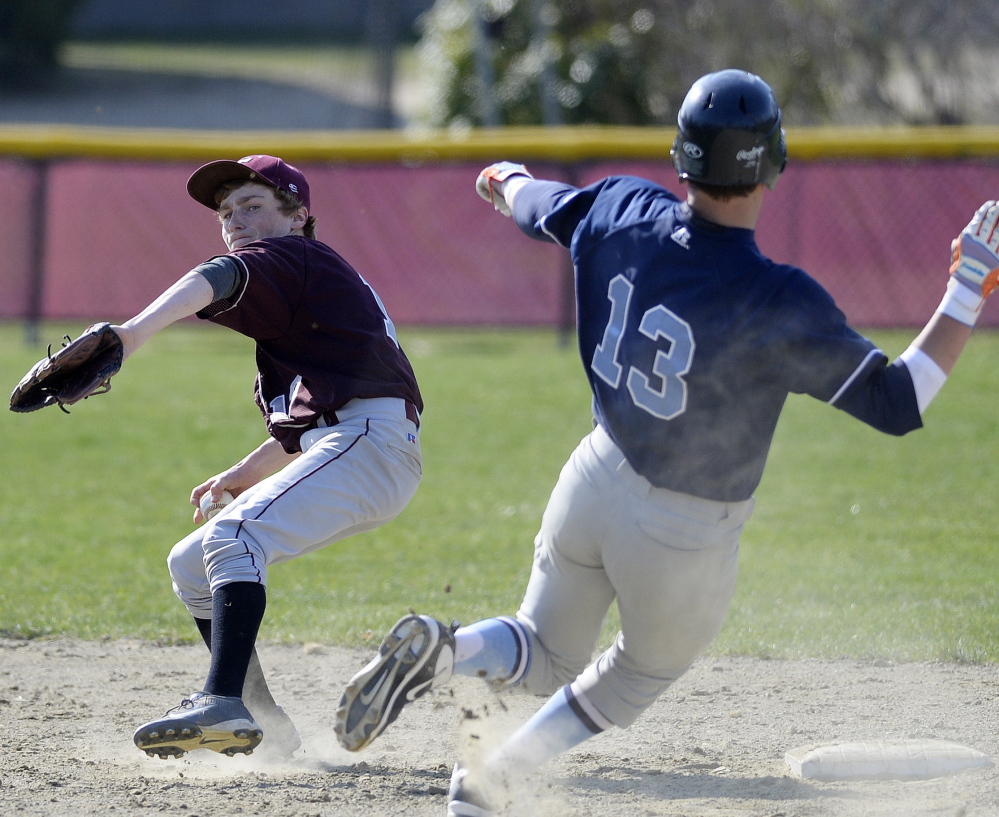 Freeport’s Max Doughty tries to turn a double play as York’s Derek Neal slides into second during the Wildcats’ 6-0 win Monday in Freeport.